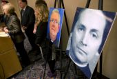 A photo of Fr. Robert Brennan, right, is displayed during a Nov. 13, 2013, news conference in Philadelphia. (AP file/Matt Rourke)