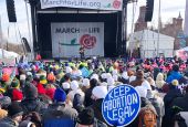 People attend the March for Life rally on the National Mall in Washington, Friday, Jan. 21, 2022. The March for Life, for decades an annual protest against abortion, arrives this year as the Supreme Court has indicated it will allow states to impose tight
