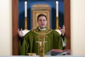 Father Matthew Hood celebrates mass at Our Lady of the Rosary church Friday, Feb. 18, 2022, in Detroit. (AP Photo/Paul Sancya)