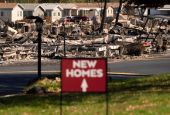 A sign in Medford, Oregon, advertises new homes amid the wildfire destruction Sept. 20, 2020. (CNS photo/David Ryder, Reuters)