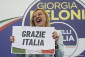 Giorgia Meloni shows a placard reading in Italian "Thank you Italy" at the Brothers of Italy party's electoral headquarters in Rome Sept. 26. (AP/Gregorio Borgia)