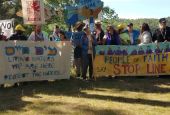 A multi-faith delegation prays before a march and rally opposing the Enbridge Line 3 pipeline near the Mississippi headwaters in northern Minnesota in early June. (Marianne Comfort)