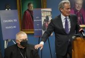 Tony Argiz, right, puts his hand on Archbishop of Miami Thomas Wenski 's shoulder as he speaks during a news conference, at the Archdiocese of Miami Pastoral Center in Miami Shores, Fla.,  Feb. 10, 2022, (AP Photo/Wilfredo Lee)