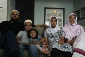 The Zakir family watches an episode of "Ms. Marvel" in Anaheim, California, on July 8. From left: father Yusuf; son Burhanuddin; Yusuf's niece, Insiya Maimoon; daughter Jumana; and mother Fareeda (AP Photo/Jae C. Hong)