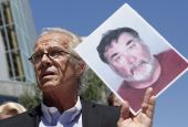 Attorney Jeff Anderson holds up a photo of former priest Stephen Kiesle at a news conference in Oakland, Calif., Wednesday, Aug. 18, 2010. (AP Photo/Jeff Chiu, File)