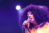 Solange holding a microphone and singing