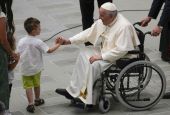 Pope Francis is greeted by a boy as he arrives for an audience with soldiers of the "Safe roads" operation and their families, at the Vatican June 11. (AP/Andrew Medichini)