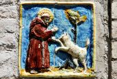 A tile in Assisi, Italy, depicts St. Francis and the wolf of Gubbio. (Wikimedia Commons/Zorro2212)