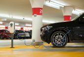 Electric vehicle charging in a garage. (Unsplash/Michael Fousert)