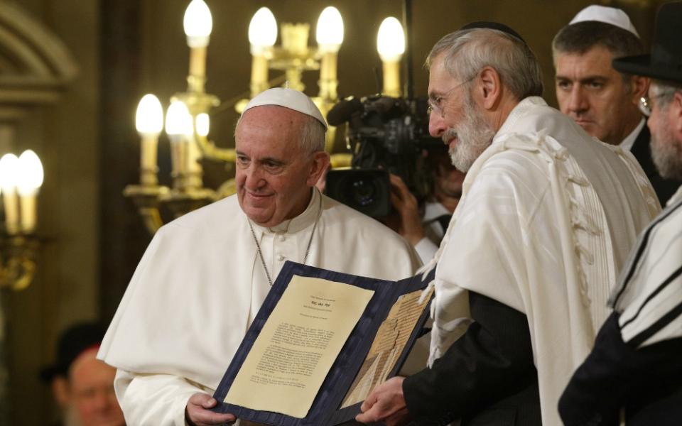 In a 2016 file photo, Pope Francis and Rabbi Riccardo Di Segni, the chief rabbi of Rome, hold a codex containing five pages of Jewish biblical commentary at the main synagogue in Rome. (CNS/Paul Haring)