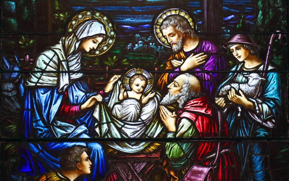 This stained-glass window at St. Aloysius Church in Great Neck, N.Y., depicts Jesus in a manger surrounded by Mary, Joseph and three shepherds. (CNS/Gregory A. Shemitz)