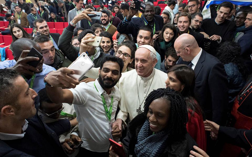 Pope Francis poses for a selfie during a pre-synod gathering of youth delegates at the Pontifical International Maria Mater Ecclesiae College in Rome March 19, 2018. The meeting was in preparation for the Synod of Bishops on young people in October 2018.