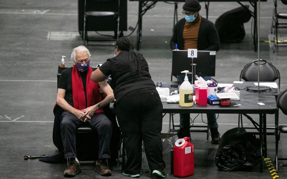 A man at the New York state COVID-19 vaccination site, the Jacob K. Javits Convention Center in New York City, receives a dose of the coronavirus vaccine Jan. 13. (CNS/Reuters/Brendan McDermid)