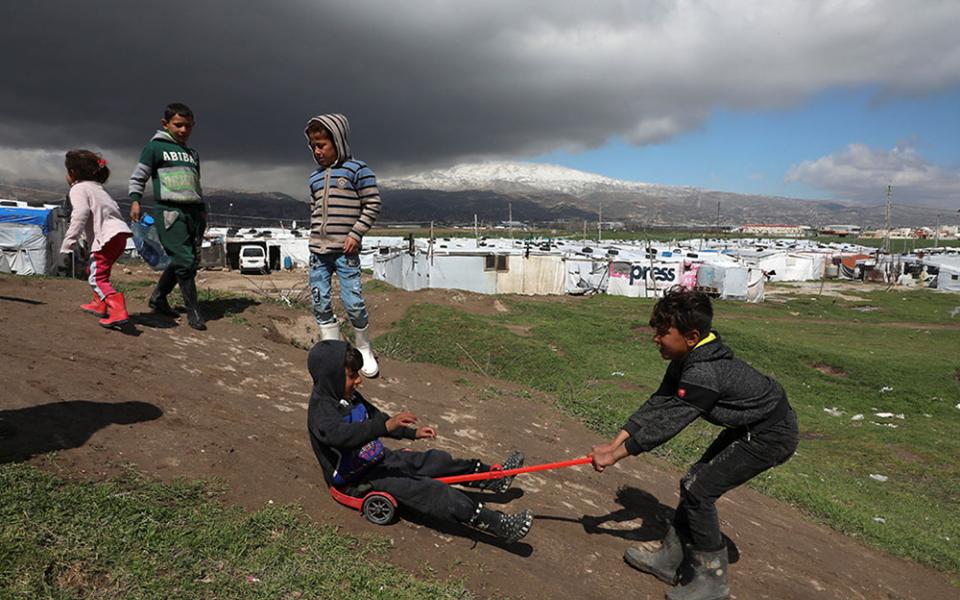 Syrian refugee children play together at an informal tent settlement in the Bekaa Valley in Lebanon March 12. (CNS/Reuters/Mohamed Azakir)