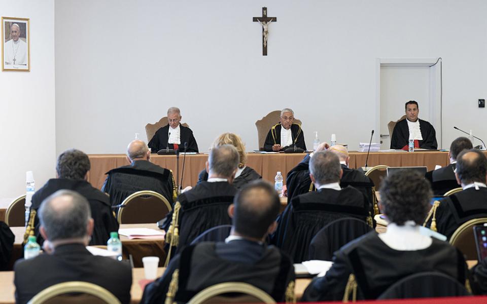 The judges of the Vatican City State criminal court — Venerando Marano, Giuseppe Pignatone and Carlo Bonzano — face dozens of lawyers in a makeshift Vatican courtroom July 27, as the trial of 10 defendants in a financial malfeasance case begins. (CNS)