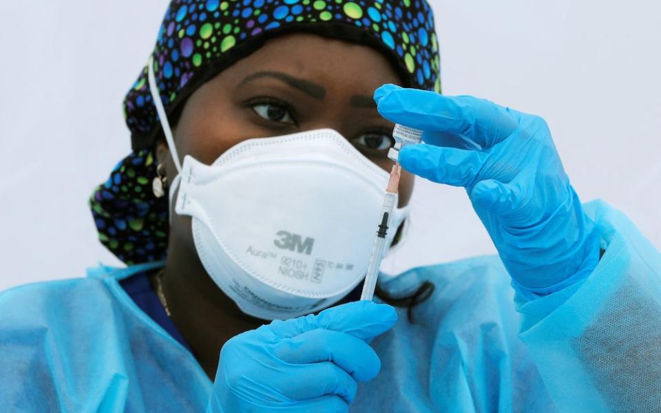 Registered nurse Sheba Phillip prepares a syringe with a dose of the Pfizer-BioNTech COVID-19 vaccine during a vaccination event for local adolescents and adults outside the Bronx Writing Academy school June 4 in New York City. (CNS/Reuters/Mike Segar)