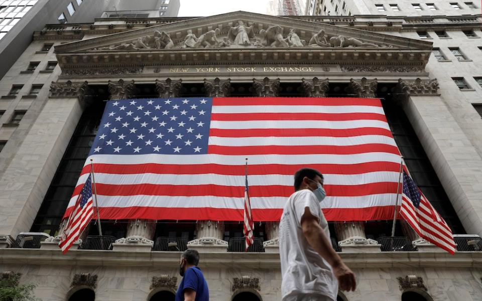 People in New York City walk by American flags Aug. 9. On Aug. 11, the Senate passed a $3.5 trillion spending package that includes immigration reform provisions, including creating a path to citizenship for 10 million people in the U.S. illegally. (CNS)
