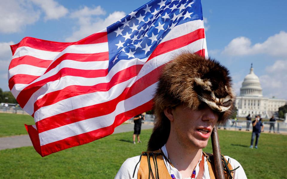 A man in Washington wearing a raccoon hat Sept. 18 talks about how he believes former President Donald Trump won the 2020 election but it was stolen from him through fraud.