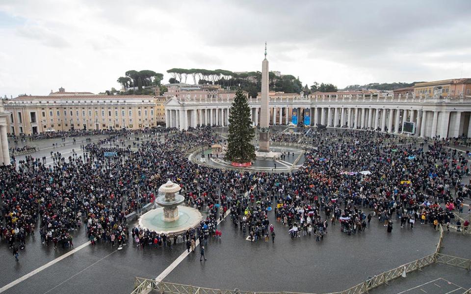 People in St. Peter's Square attend the Angelus led by Pope Francis from the window of his studio overlooking the square at the Vatican Jan. 6, the feast of the Epiphany. (CNS/Vatican Media)