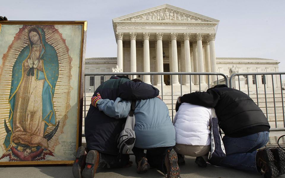 March for Life participants kneel in prayer alongside an image of Our Lady of Guadalupe in front of the Supreme Court building Jan. 24, 2011, in Washington. (CNS/Reuters/Jim Young)