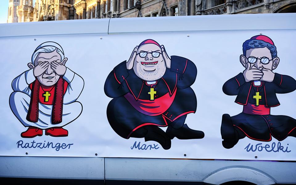  large poster is attached to a van Jan. 19 in Munich, depicting retired Pope Benedict XVI, Cardinal Reinhard Marx of Munich and Freising, and Archbishop Rainer Maria Woelki of Cologne, during a demonstration in protest of church handling of abuse. (CNS)
