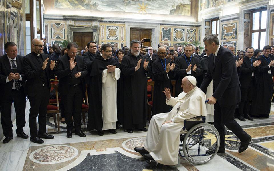 Pope Francis is pushed in a wheelchair by his aide, Sandro Mariotti, as he leaves an audience with students and professors of Rome's Pontifical Institute of Liturgy at St. Anselm, May 7 at the Vatican. (CNS/Vatican Media)
