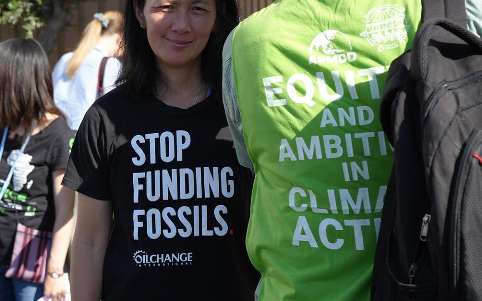 A protester wears a t-shirt with the message "Stop funding fossils" during a demonstration at the COP27 climate summit in Sharm el-Sheikh, Egypt, Nov. 9, 2022. Over 50 activists of all ages and backgrounds took over the so-called "Blue Zone" — the central area of the conference center in Sharm el-Sheikh — to chant, "Stop funding fossil fuels! Stop funding death!" (EarthBeat photo/Doreen Ajiambo)