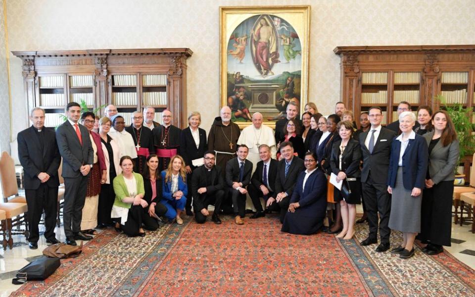 Pope Francis poses for a photograph with staff and members of the Pontifical Commission for the Protection of Minors and its leadership.