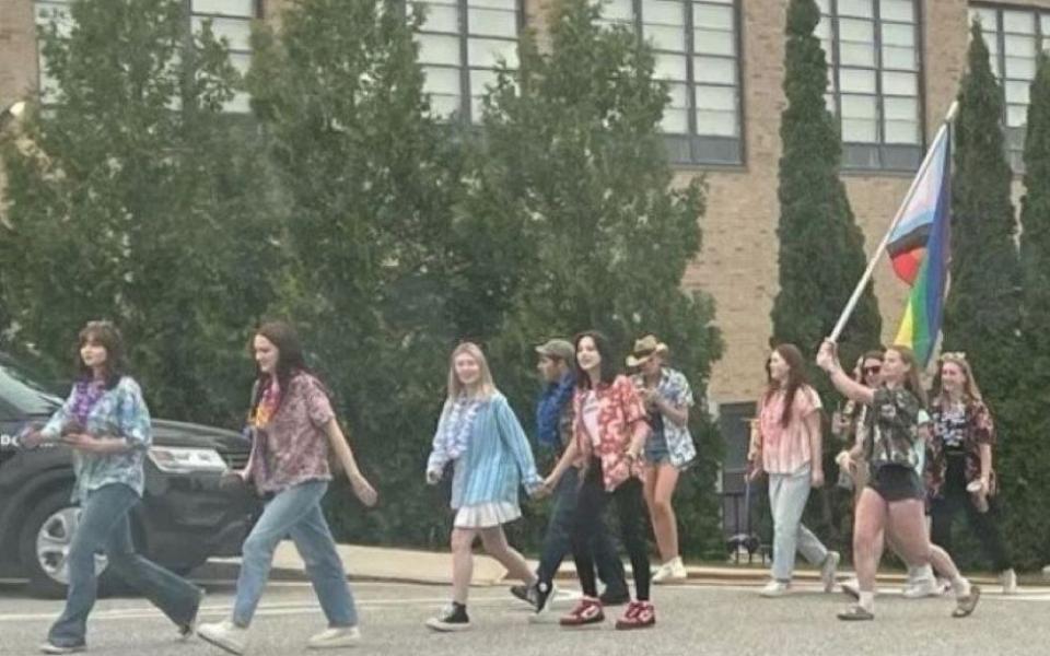 On the last day of class for seniors at St. Thomas Aquinas in Dover, New Hampshire, soon-to-be graduates carry a flag in support of the school's LGBTQ community and four teachers whose contracts were not renewed.