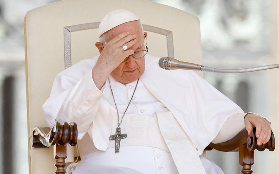 Pope Francis places his hand on his forehead during his weekly general audience in St. Peter's Square June 7 at the Vatican. (CNS/Lola Gomez)
