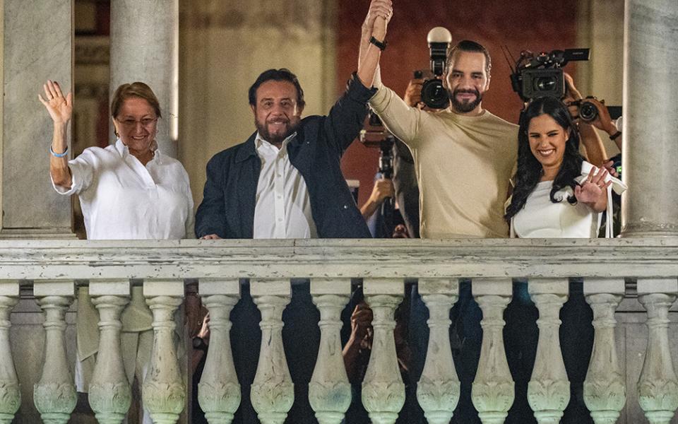 El Salvador President Nayib Bukele, second from right, his wife Gabriela Rodriguez, right, running mate and Vice President Félix Ulloa, second from left, and his wife Lilian Alvarenga wave to supporters from the balcony of the presidential palace after general elections polls closed Feb. 4 in San Salvador, El Salvador. (AP photo/Moises Castillo)