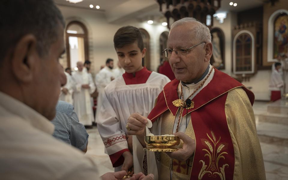 Chaldean Patriarch Louis Sako holds service at Mar Youssef Cathedral July 30, 2023, in Irbil, Iraq. In 2023 The Iraqi government revoked a decree that formally recognized Sako's religious status. Sako fled the capital for the autonomous Kurdistan region. (AP photo/Julia Zimmermann/Metrography)