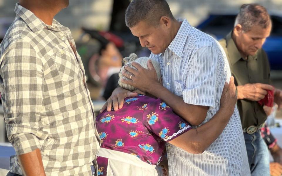 Santos Alfaro Ayala hugs his mother during Mass April 13, 2024 in Guarjila, El Salvador. Alfaro, a Catholic husband and father of two, offered his testimony of being unjustly detained for almost three months.