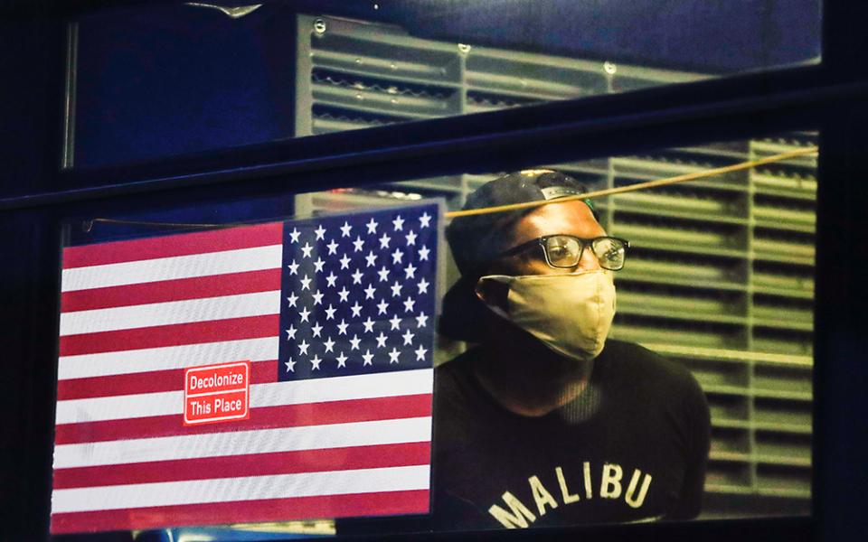 On May 29, 2020, in the Brooklyn borough of New York, a demonstrator who was arrested waits in the back of a bus during a protest against the death of George Floyd, a black man who died after being restrained by Minneapolis police officers on Memorial Day. (AP/Frank Franklin II)