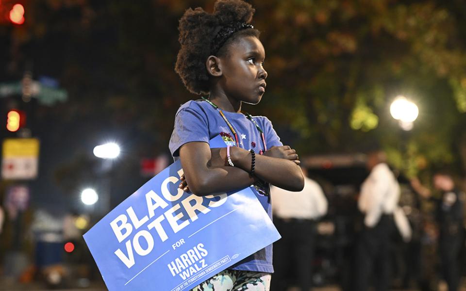 A young girl holds a "Black Voters for Harris-Walz" sign outside of Democratic presidential nominee Vice President Kamala Harris' election night watch party at Howard University, Tuesday, Nov. 5 in Washington. (AP photo/Terrance Williams)