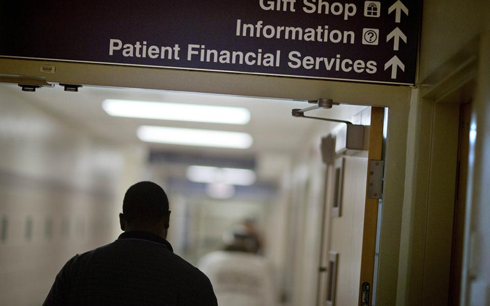 A sign points visitors toward the financial services department at a hospital in this file photo. The Catholic Health Association has issued a plea to congressional leadership asking them to reject funding cuts and structural changes to Medicaid. (AP photo/David Goldman, File)
