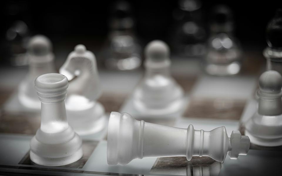 A close-up of a chess board shows translucent pieces (Unsplash/Peter Law)