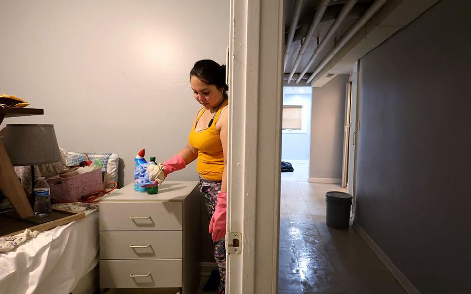Patricia Medina cleans her flood-damaged apartment along the 1900 block of South 51st Court in Cicero, Illinois, on July 3, 2023. After the flooding, longtime residents of Cicero and Berwyn started a grassroots community organizing group to respond to the area's environmental concerns. (Stacey Wescott/Chicago Tribune/TNS)