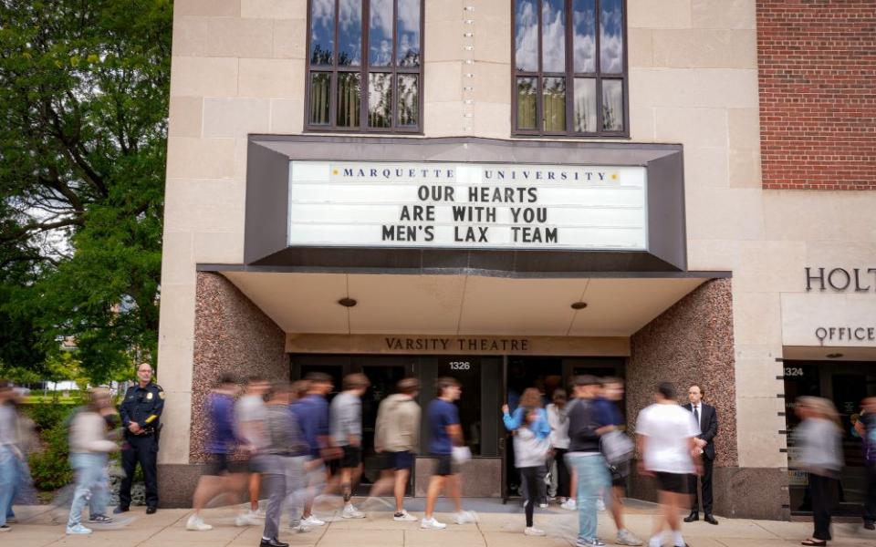 An overflow crowd packed the theater and lobby of Marquette University's Varsity Theatre for a memorial Mass for two college lacrosse players killed in a crash by alleged drunken driver Sept. 6. (Clay Ellis-Escobar)