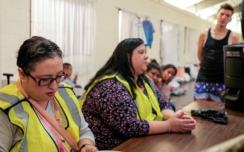 Imelda Maynard, director of legal services of Estrella del Paso, formerly Diocesan Migrant and Refugee Services, and Melissa López, executive director, provide legal information to migrants in a migrant shelter in El Paso, Texas. (OSV News/Courtesy of Diocesan Migrant and Refugee Services, Inc. of El Paso)