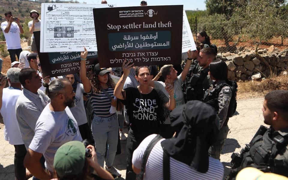 Amira Musallam protests during a nonviolent march to protest the illegal settlers' annexation of Palestinian land in Beit Jala, West Bank, to which Israeli authorities responded with the use of force and stun grenades, in August 2024. (Courtesy of Amira Musallam)
