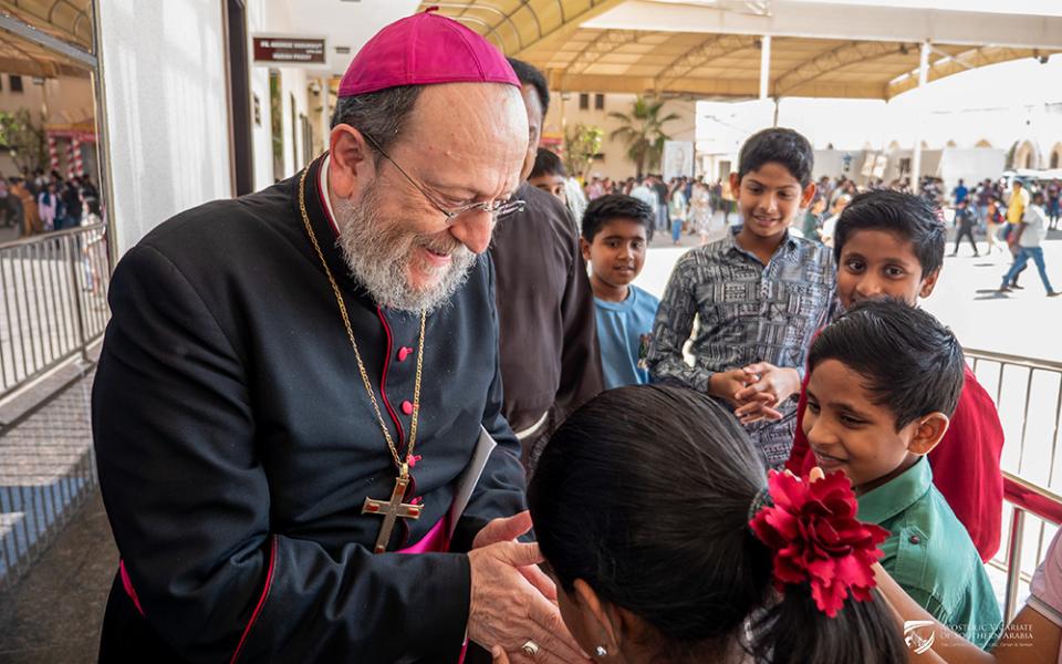 Bishop Paolo Martinelli, apostolic vicar of Southern Arabia, greets children during a pastoral visit in February 2026. (Courtesy of Apostolic Vicariate of Southern Arabia)
