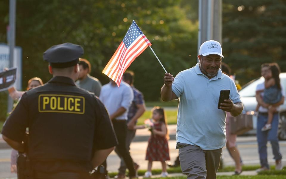 A man holds a U.S. flag as he attends a pro-immigrant march and rally following a Spanish-language Mass at St. John the Evangelist Church in Riverhead, N.Y., June 22, 2025, the feast of the Body and Blood of Christ. St. John's parish social ministry organized the event, which drew about 300 participants. (OSV News/Gregory A. Shemitz)