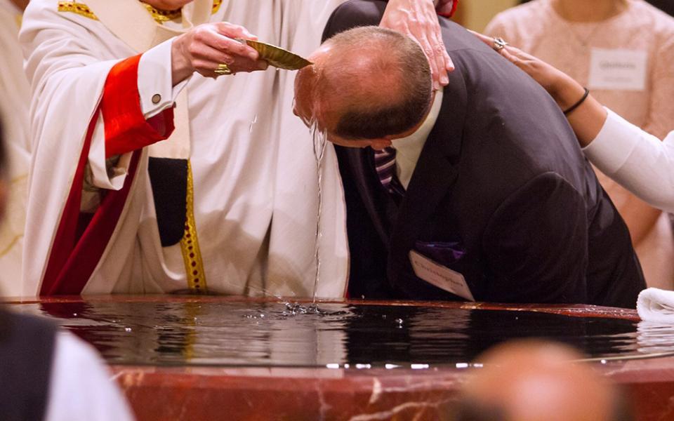 A file photo shows a catechumen being baptized during the Easter Vigil. (OSV News/Texas Catholic Herald/James Ramos)
