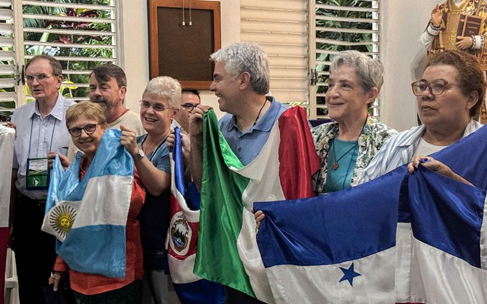 Members of the Confederation of Latin American and Caribbean Religious hold flags from various Latin American countries as they sing in a chapel during a board meeting March 21, 2026, in the Dominican Republic. CLAR affirmed its commitment to the process that Pope Francis called "walking together," or synodality. (GSR photo/Rhina Guidos)