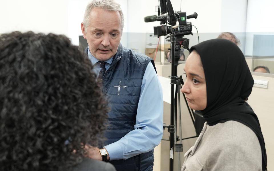 J. Antonio Fernández, CEO of Catholic Charities of the Archdiocese New York, and Faiza Ali, commissioner at the New York City Mayor's Office of Immigrant Affairs York, visit booths where volunteers held an immigration information phone bank to offer guidance and respond to local immigrants' concerns April 21. (Courtesy of Catholic Charities of the Archdiocese of New York)