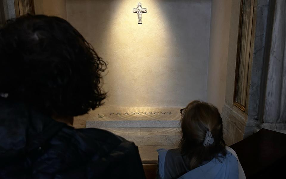 Pilgrims gather around the tomb of Pope Francis along the side of the Basilica of St. Mary Major in Rome. (NCR photo/Justin McLellan)