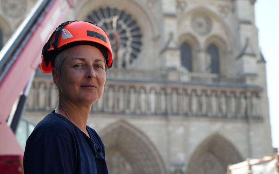 Camille Colonna, archaeologist in charge of operations, wearing a safety helmet, poses in front of Notre Dame Cathedral during excavations in Paris June 1, 2026. (AP/Nicolas Garriga)
