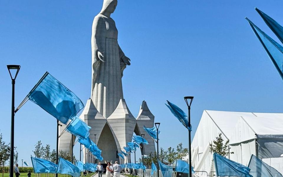 People walk inside an enormous statue of the Virgin Mary that is believed to be Europe's tallest during the inauguration in the village Konotopie, Poland, Aug. 15, 2026. (AP/Claudia Ciobanu)