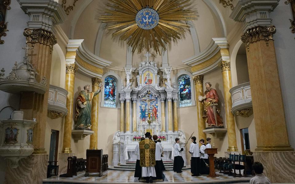 Fr. John Ubel, pastor of the Church of Saint Agnes, processes into the sanctuary with altar servers at the start of one of the Catholic parish's Latin Masses in St. Paul, Minn., June 28, 2026. (RNS/AP/Giovanna Dell'Orto)